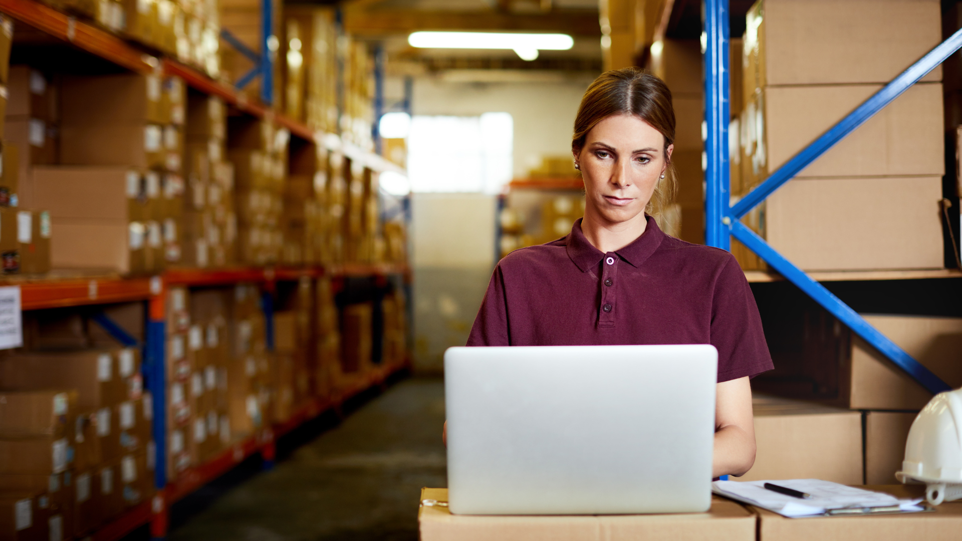 Woman in warehouse working with Software OSCA for Supplier Relationship Management